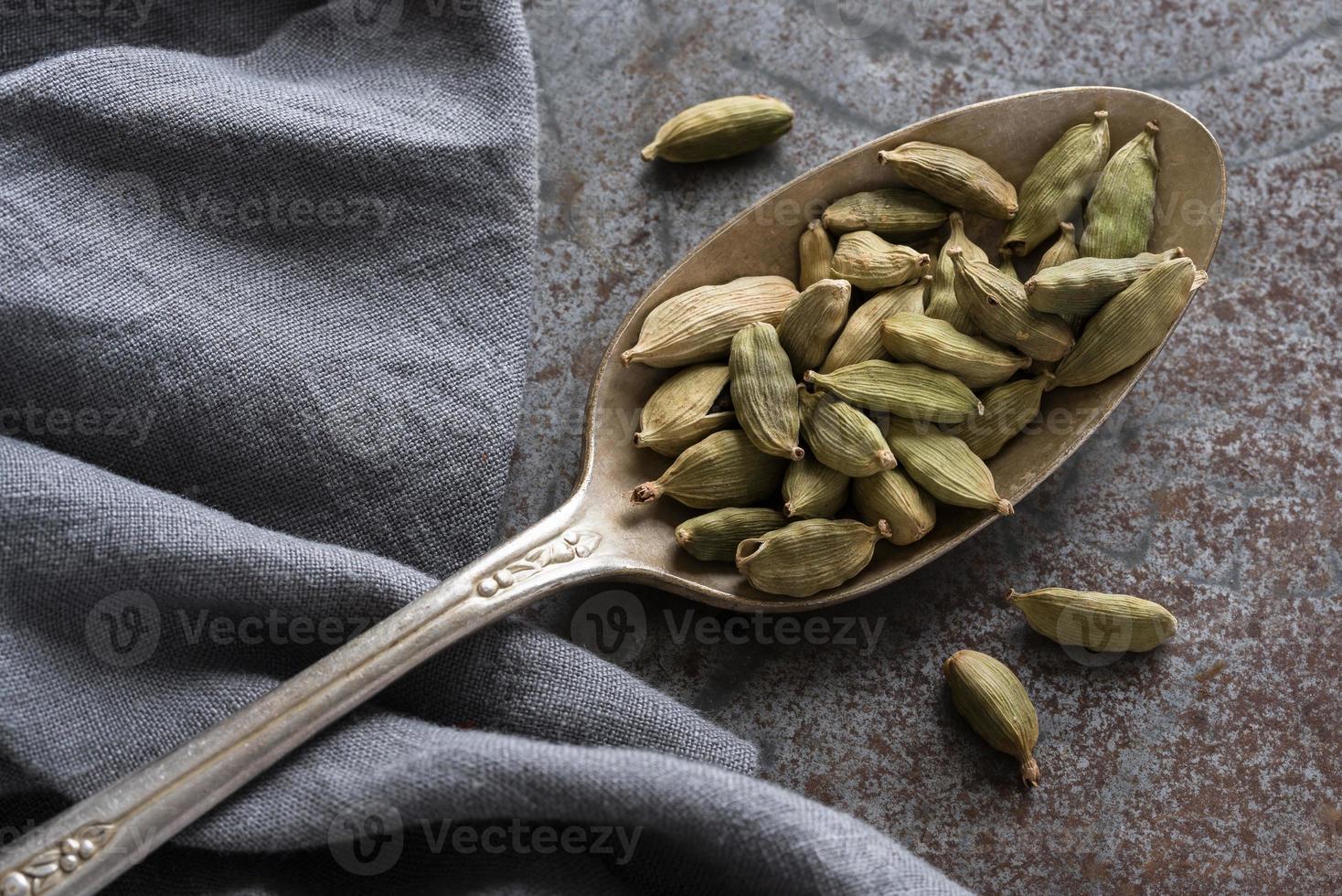 Green Cardamom Pods on a Vintage Spoon photo