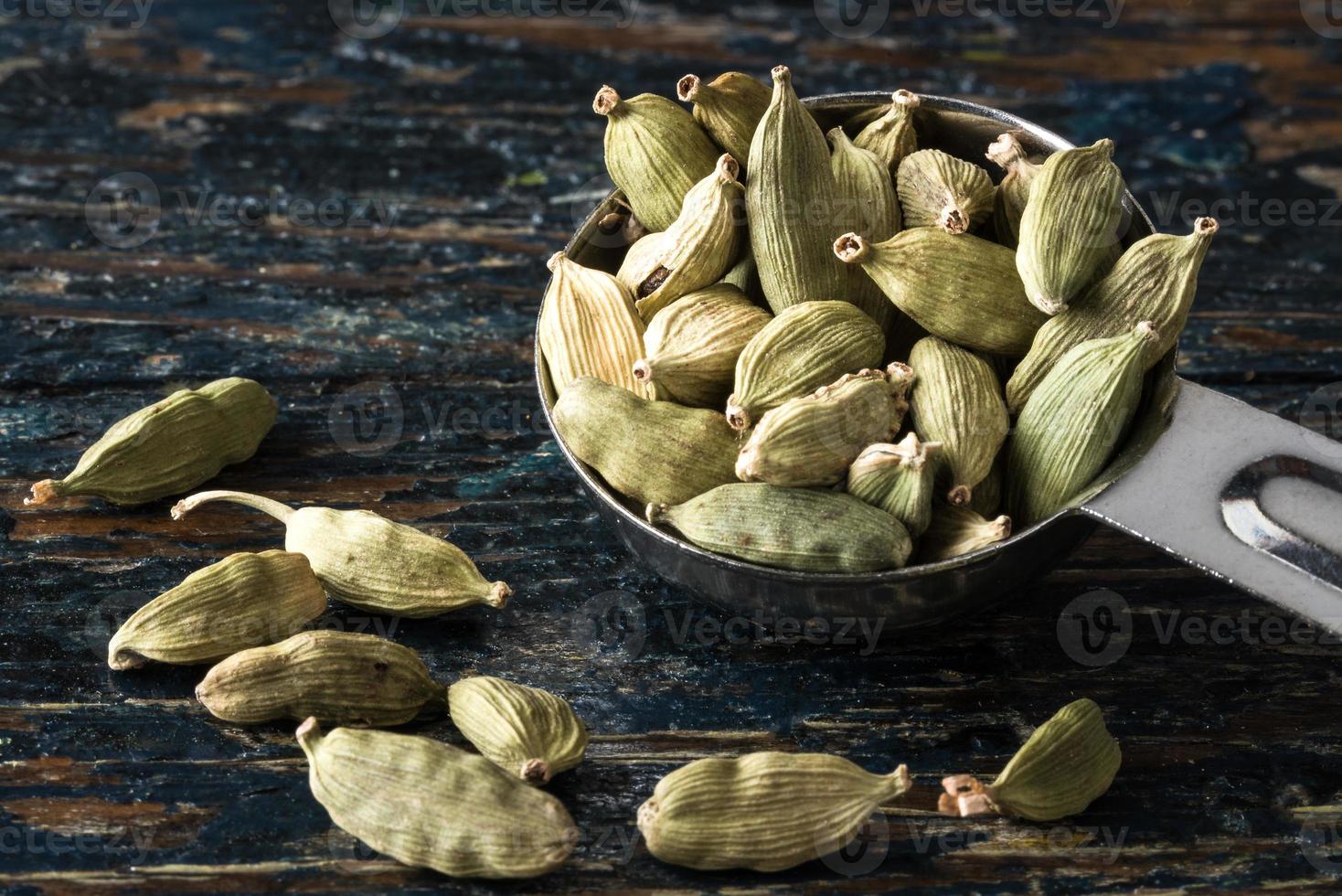 Green Cardamom Pods Spilled from a Teaspoon photo
