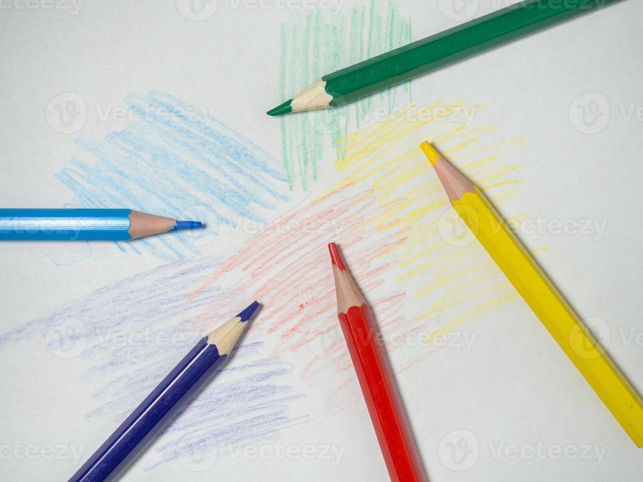 Colored wooden pencils on  paper. Sharpened pencils. Drawing tool.  Accessories for creativity. photo