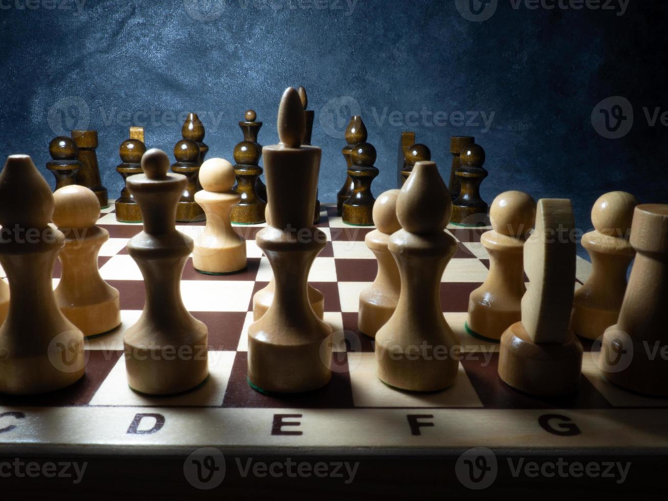 Chess board with figures. Wooden chess. Board games. Location of opponents. Counter strategy. photo