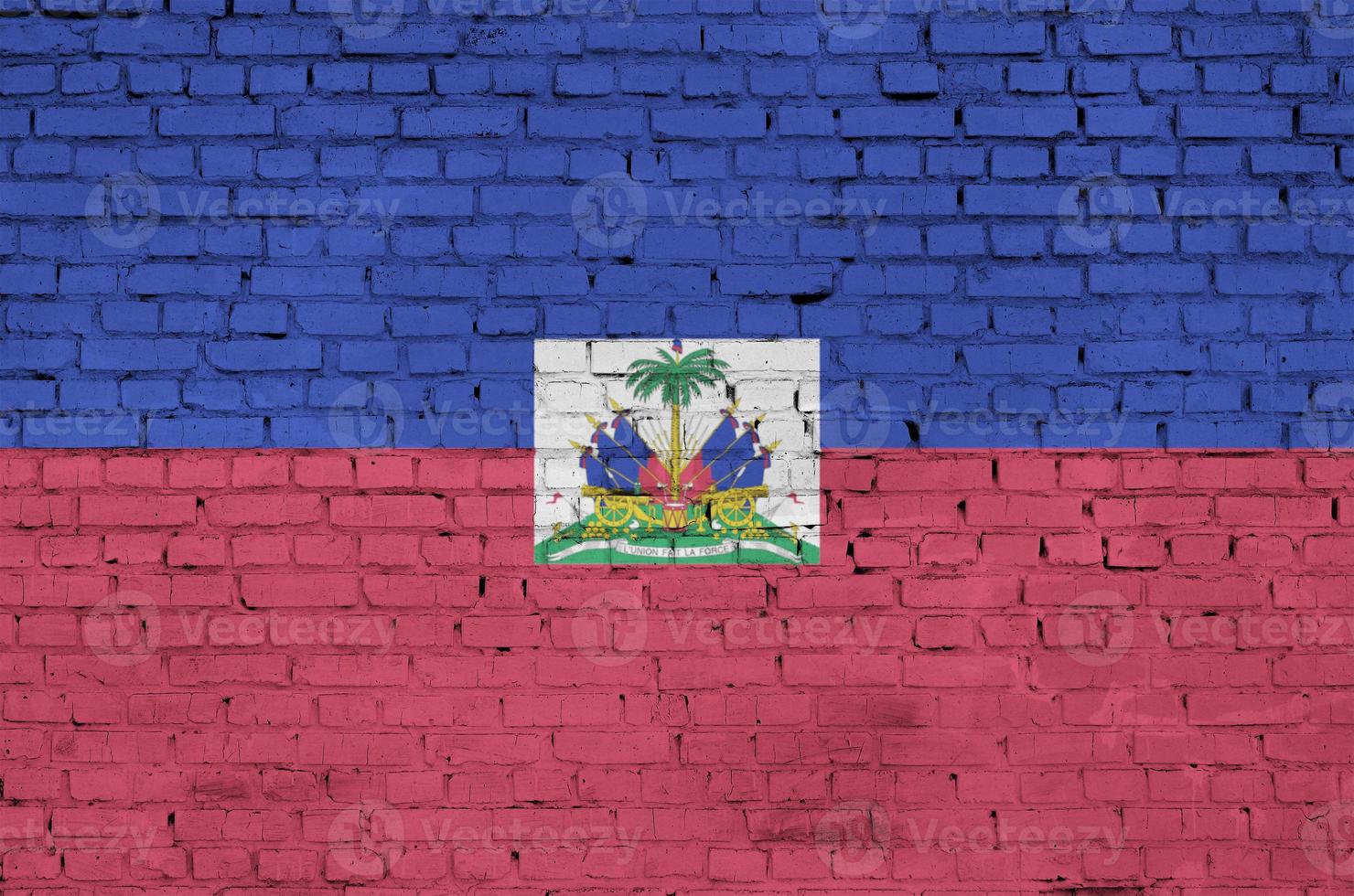 Haiti flag is painted onto an old brick wall photo