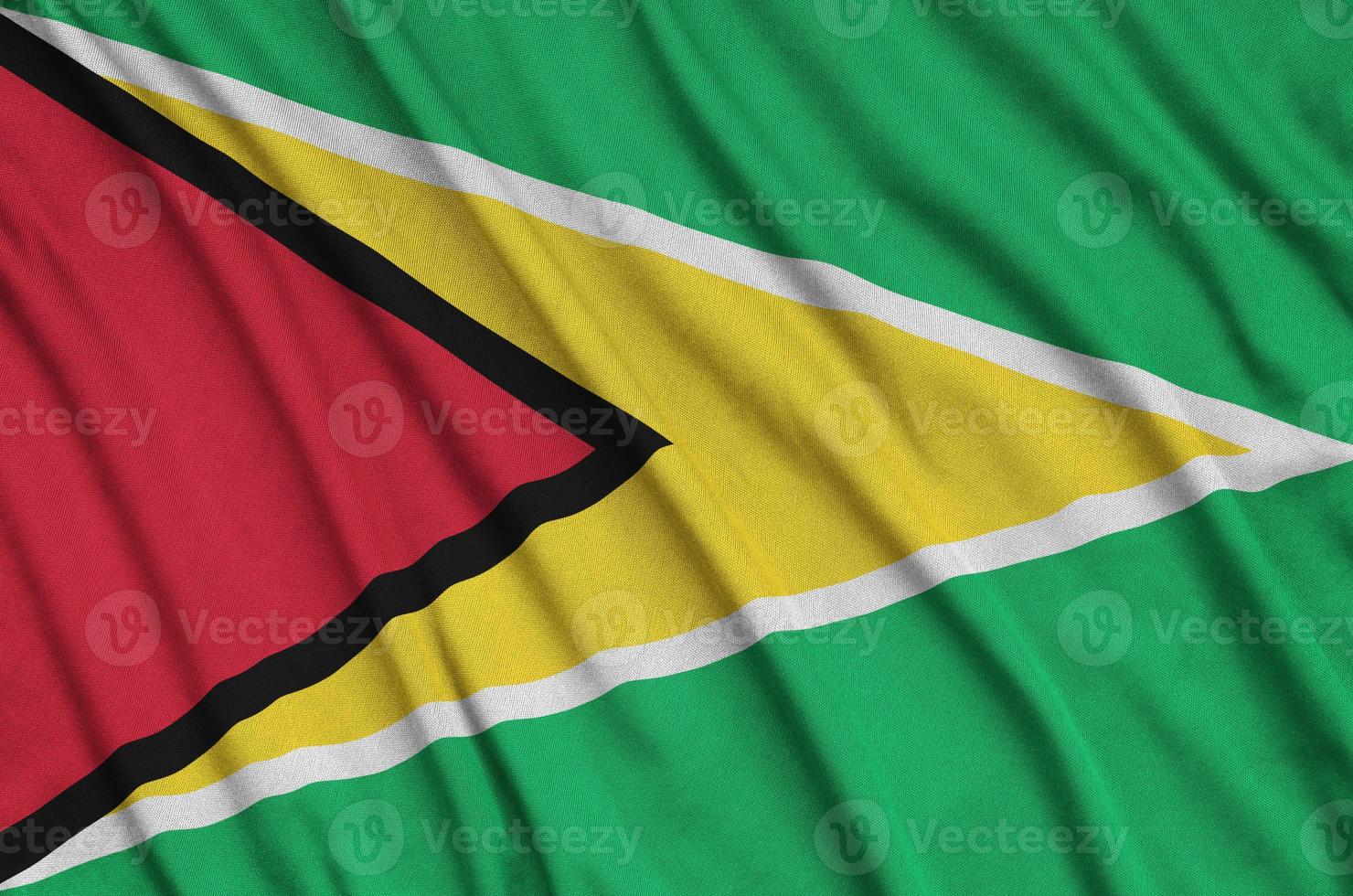 Guyana flag is depicted on a sports cloth fabric with many folds. Sport team banner photo