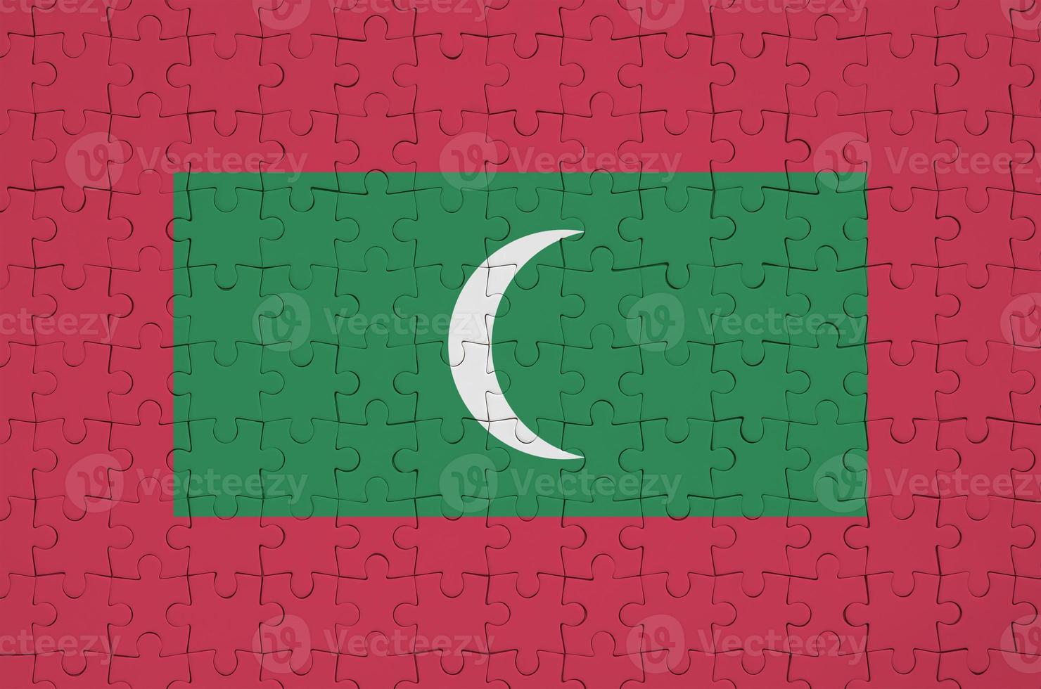 Maldives flag is depicted on a folded puzzle photo