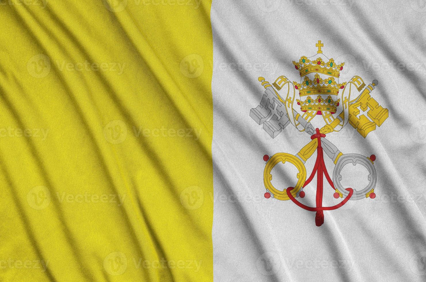 Vatican City State flag is depicted on a sports cloth fabric with many folds. Sport team banner photo