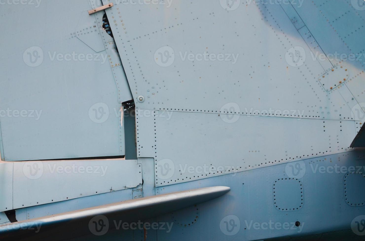 Dirty detailed texture of old fighter aircraft body painted in camouflage with many rivets photo