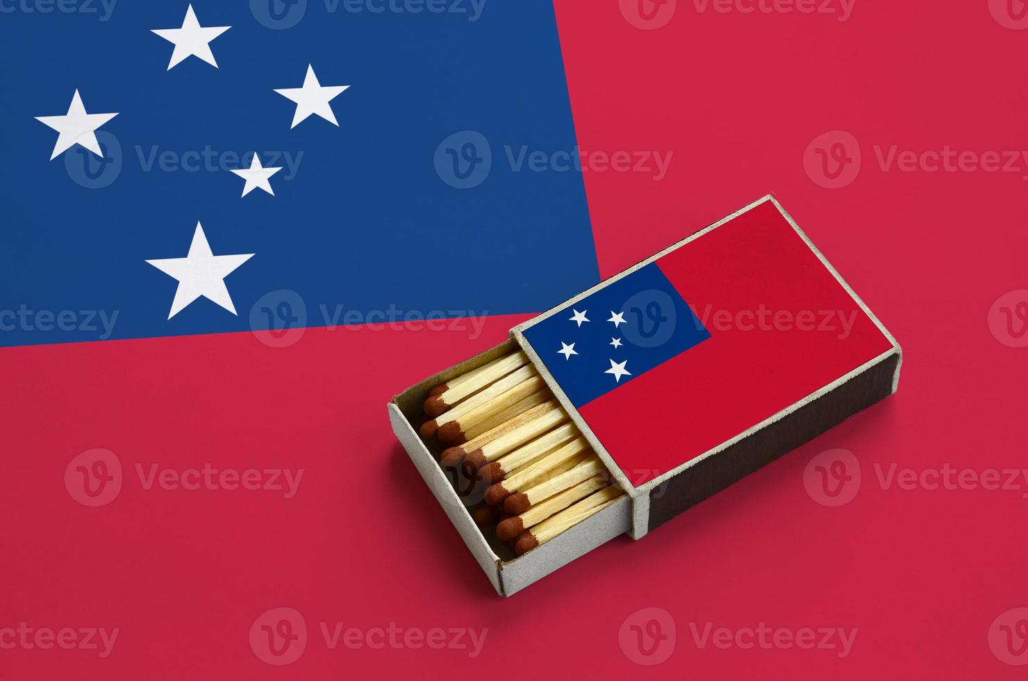 Samoa flag is shown in an open matchbox, which is filled with matches and lies on a large flag photo