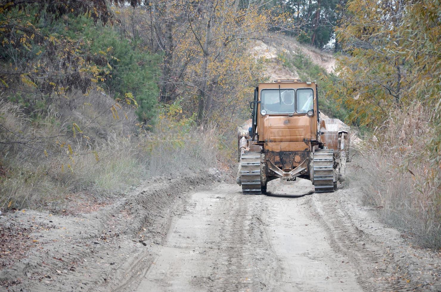 Quarry aggregate with heavy duty machinery. Caterpillar loader Excavator with backhoe driving to construction site quarry photo