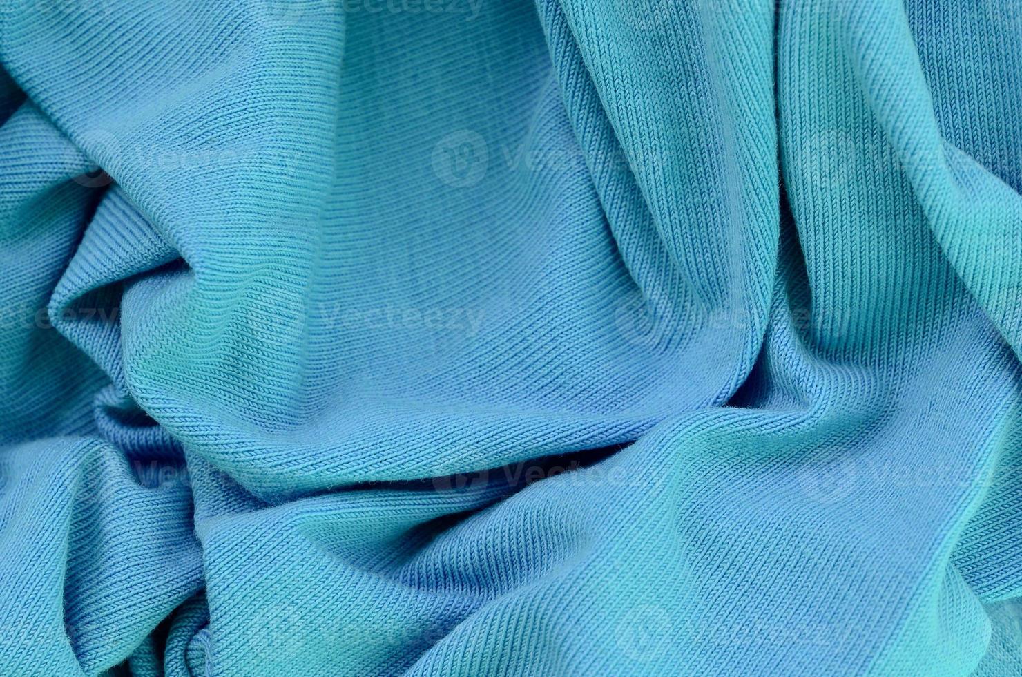 The texture of the fabric in blue color. Material for making shirts and blouses photo