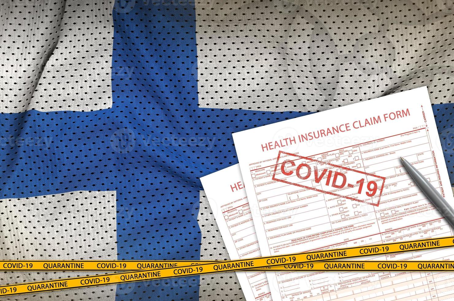 Finland flag and Health insurance claim form with covid-19 stamp. Coronavirus or 2019-nCov virus concept photo