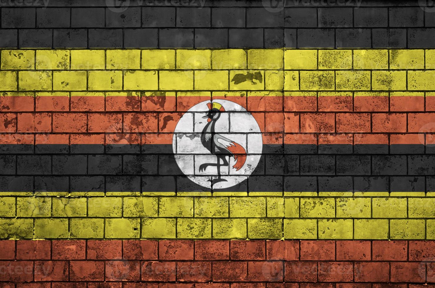Uganda flag is painted onto an old brick wall photo