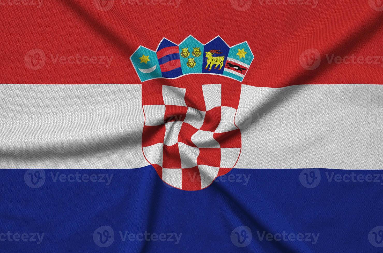 Croatia flag is depicted on a sports cloth fabric with many folds. Sport team banner photo