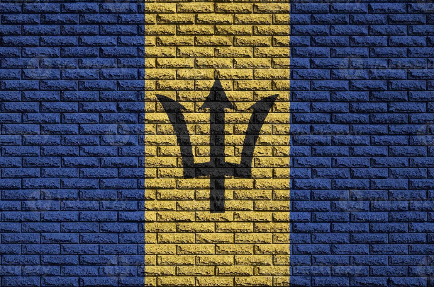 Barbados flag is painted onto an old brick wall photo