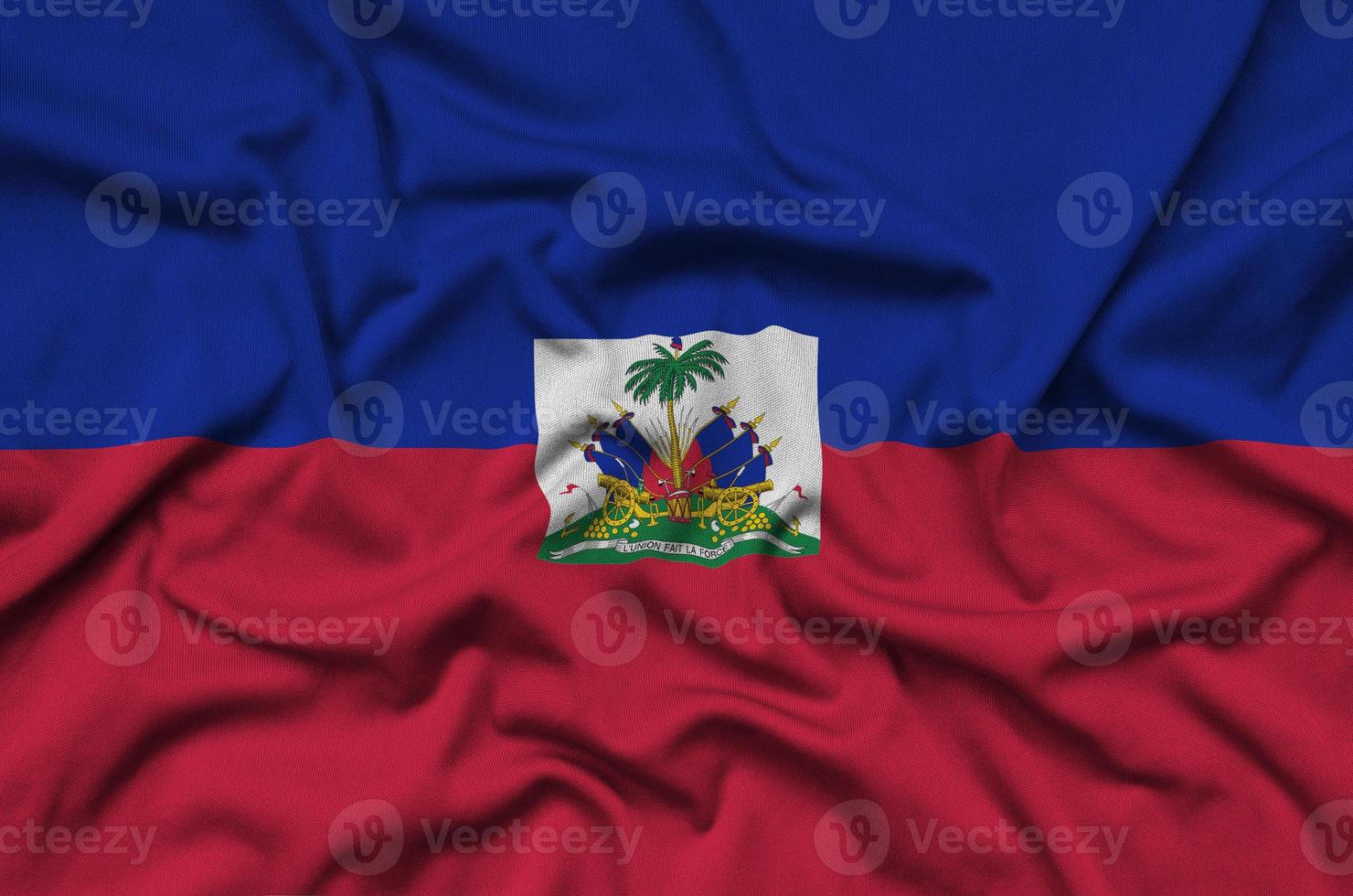 Haiti flag is depicted on a sports cloth fabric with many folds. Sport team banner photo