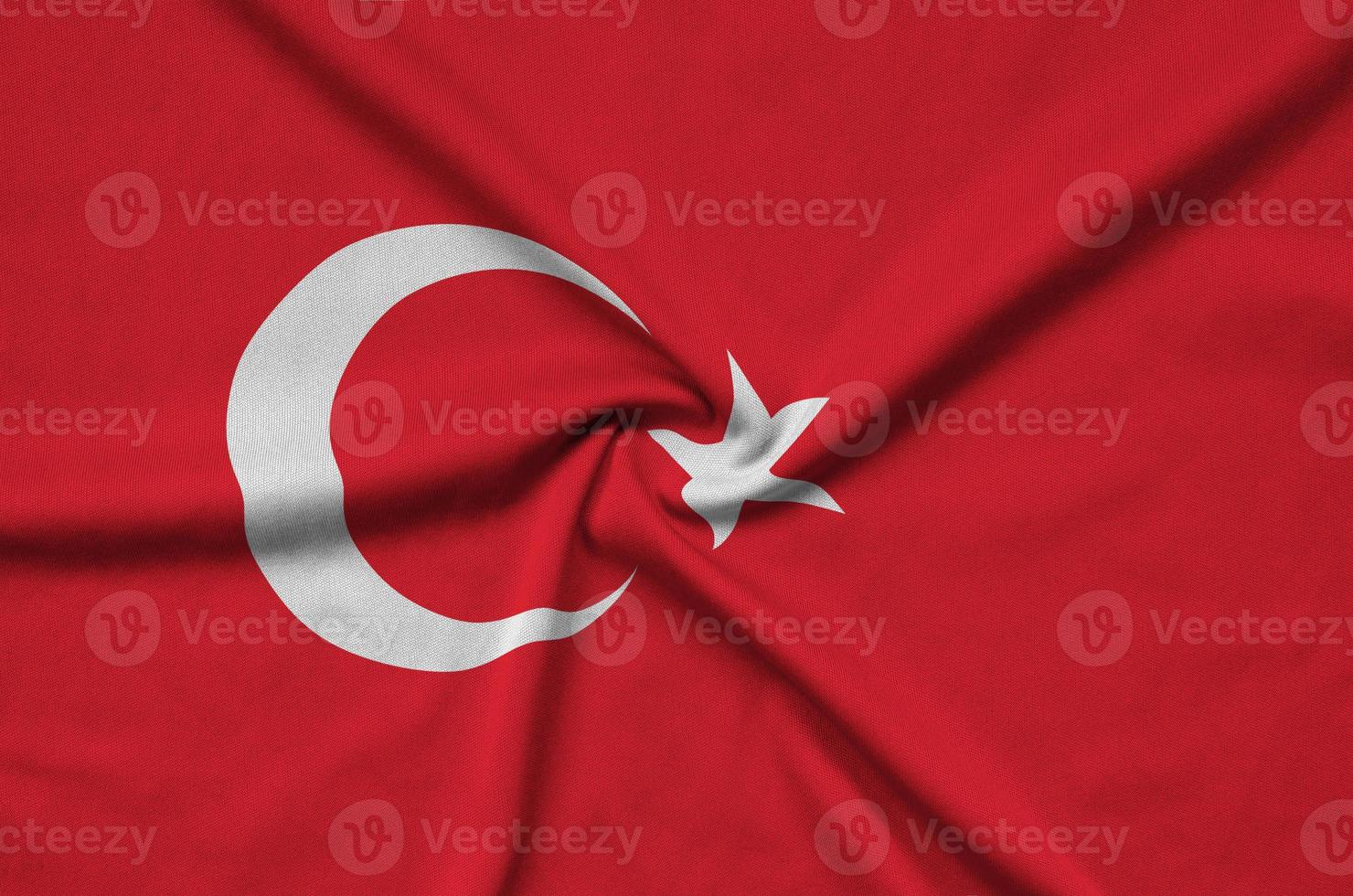 Turkey flag is depicted on a sports cloth fabric with many folds. Sport team banner photo