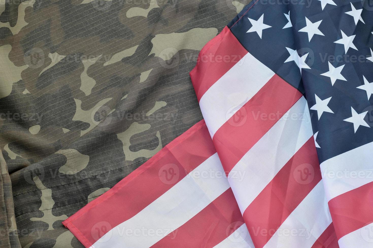 United States of America flag and folded military uniform jacket. Military symbols conceptual background banner for american patriotic holidays photo
