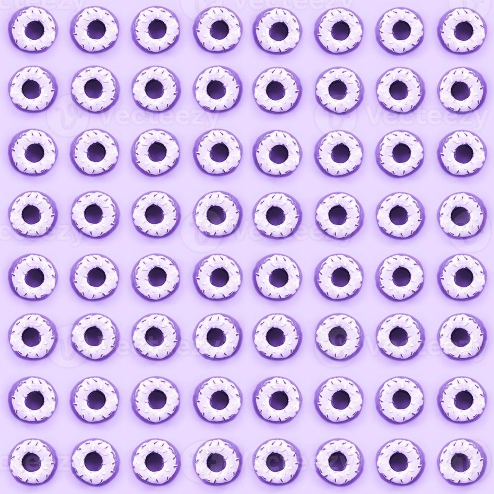 Many small plastic donuts lies on a pastel colorful background. Flat lay minimal pattern. Top view photo