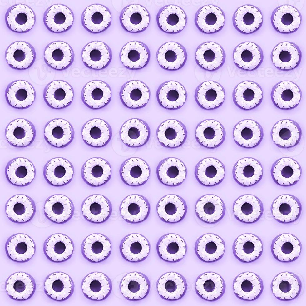 Many small plastic donuts lies on a pastel colorful background. Flat lay minimal pattern. Top view photo