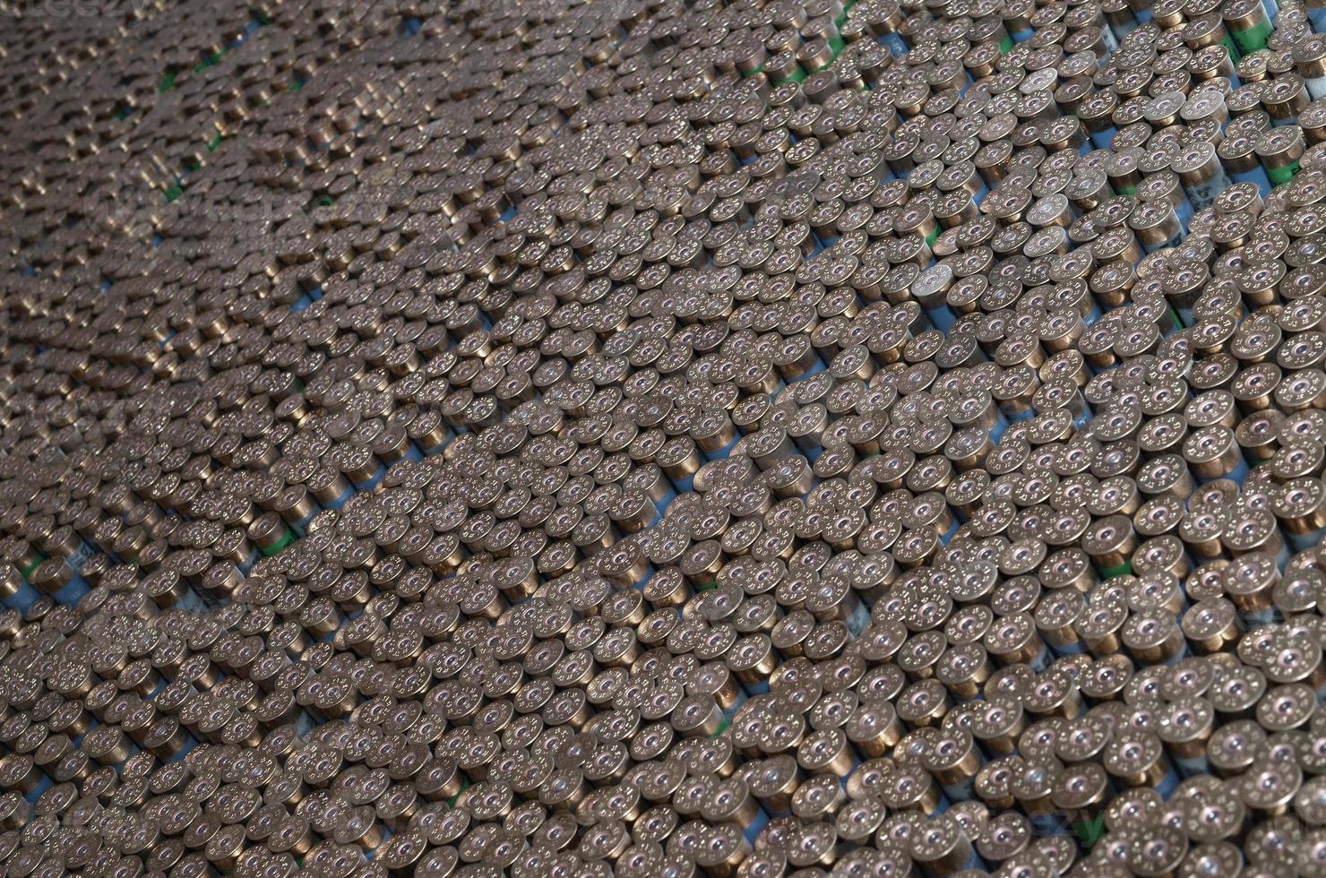 Pattern of 12 gauge cartridges for shotgun bullets. Shells for hunting rifle close up. Backdrop for shooting range or ammunition trade concepts photo