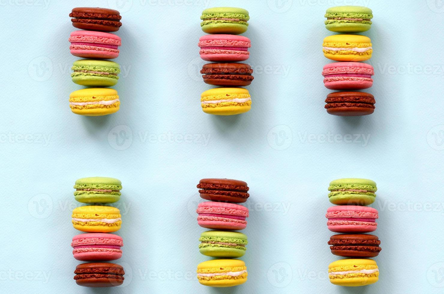 Dessert cake macaron or macaroon on trendy pastel blue background top view. Flat lay composition photo