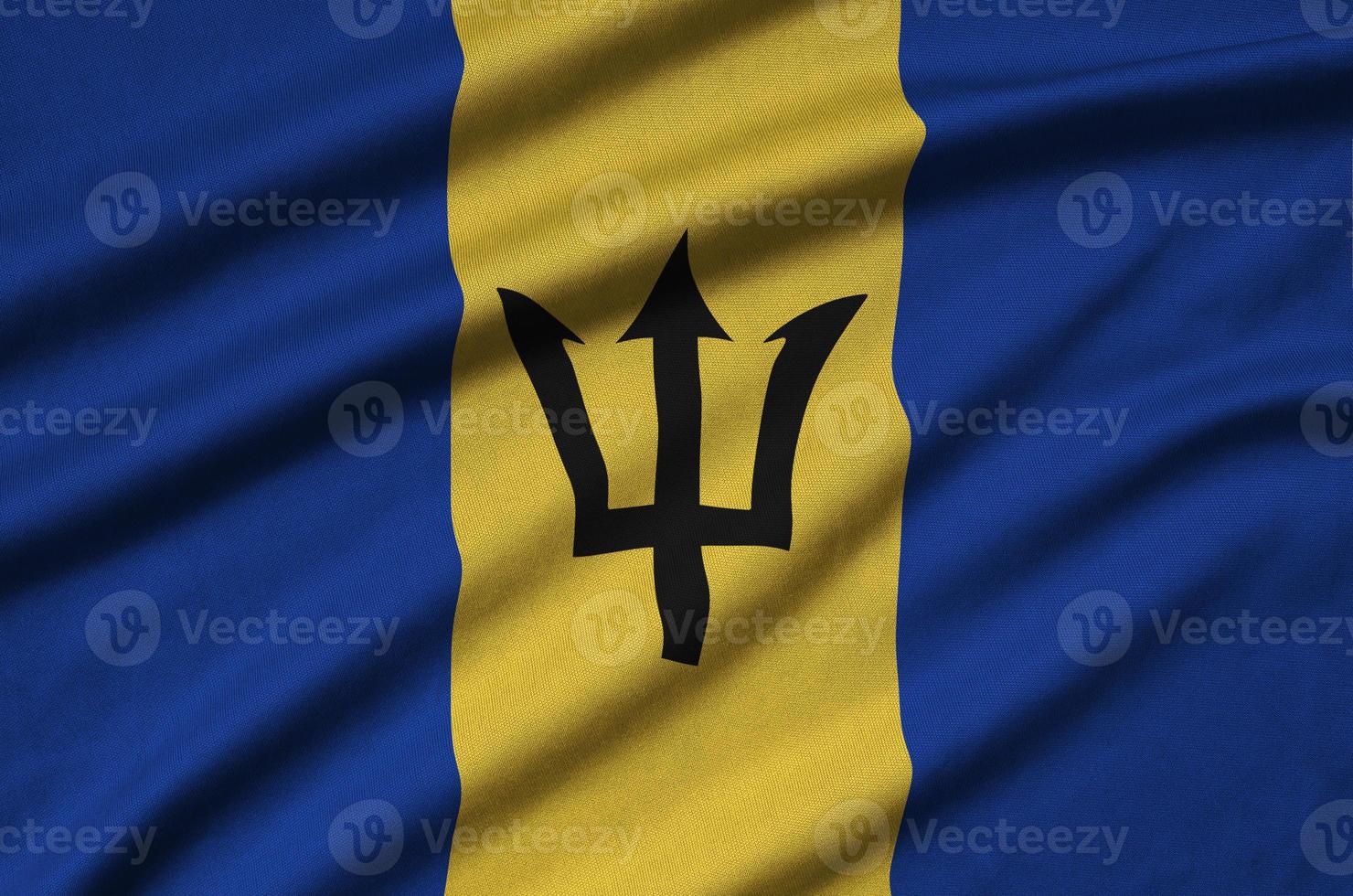 Barbados flag is depicted on a sports cloth fabric with many folds. Sport team banner photo