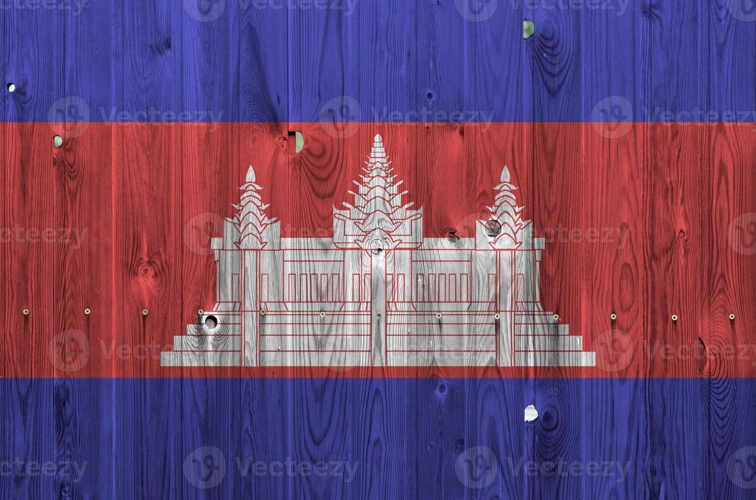 Cambodia flag depicted in bright paint colors on old wooden wall. Textured banner on rough background photo