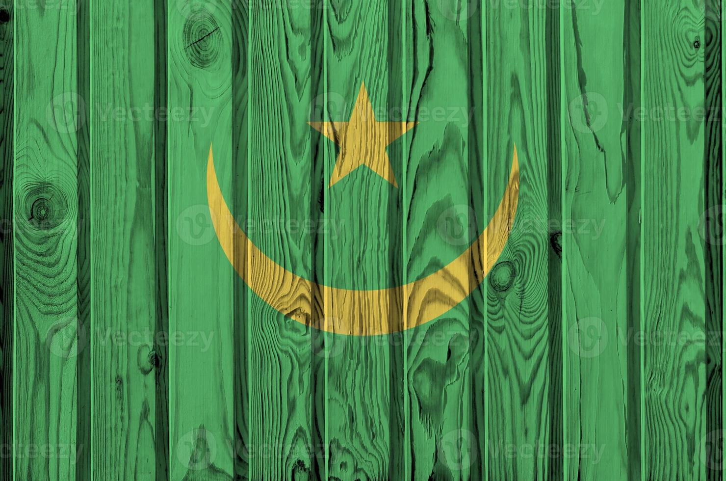 Mauritania flag depicted in bright paint colors on old wooden wall. Textured banner on rough background photo