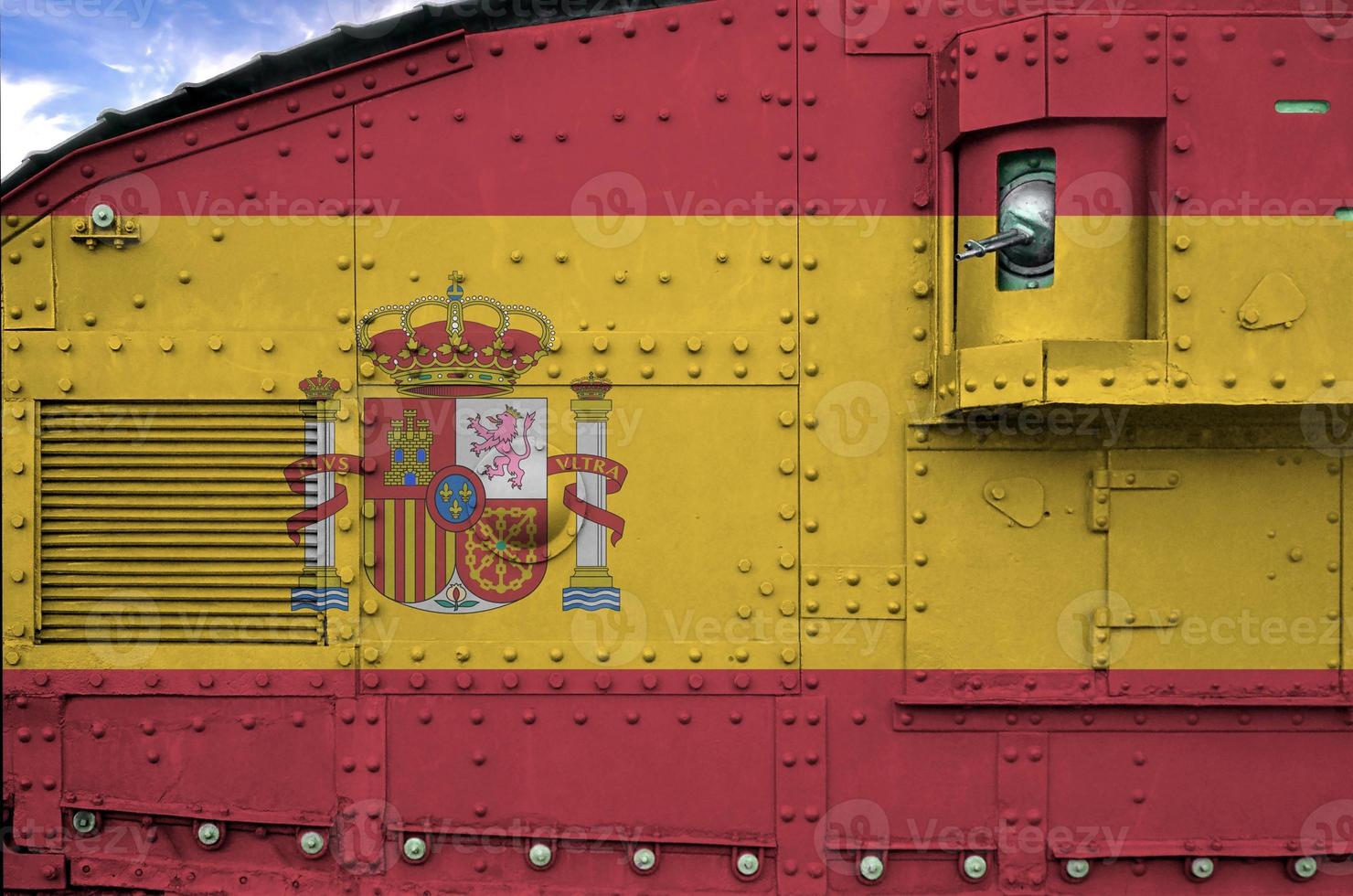 Spain flag depicted on side part of military armored tank closeup. Army forces conceptual background photo