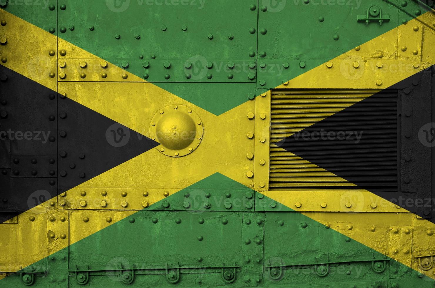 Jamaica flag depicted on side part of military armored tank closeup. Army forces conceptual background photo