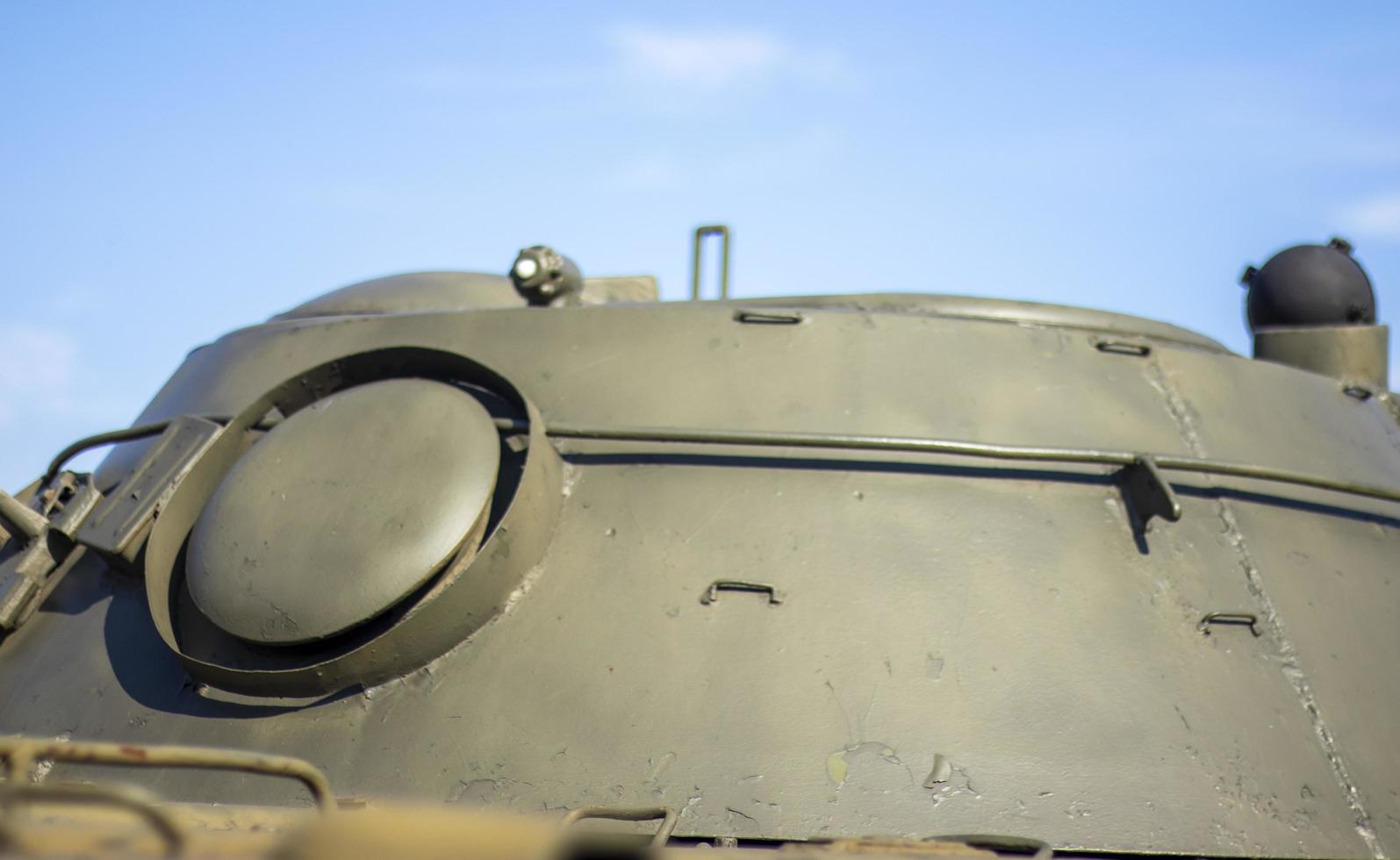 Tower of an armored personnel carrier or tank. Heavy weapons of war, sky background. Army equipment for combat and defense. Cannon tower. Details of military equipment. Close-up. photo