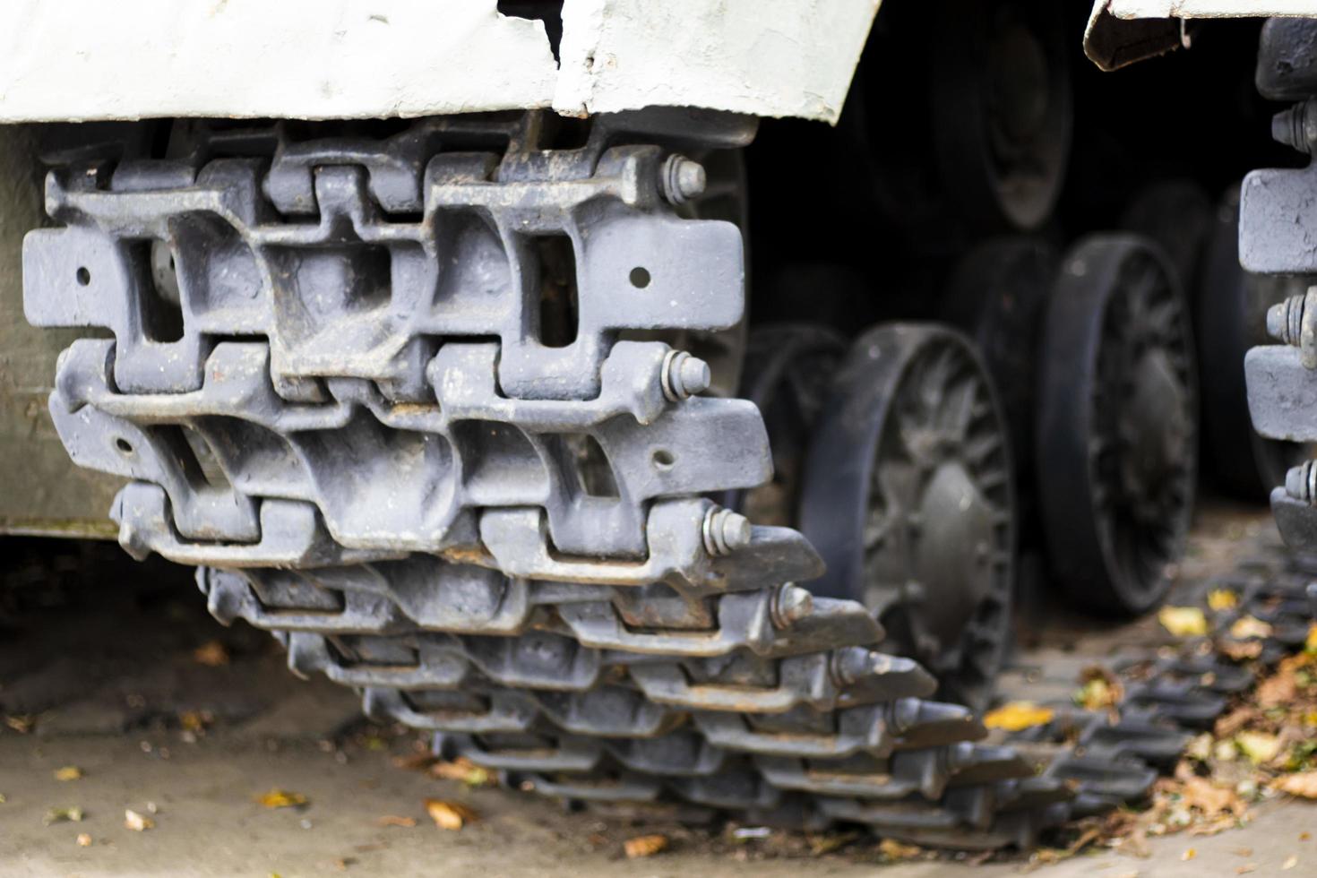 Caterpillar and rollers of a green battle tank. Military army concept. Close-up camera movements. Caterpillar wheels. Tank up close. photo
