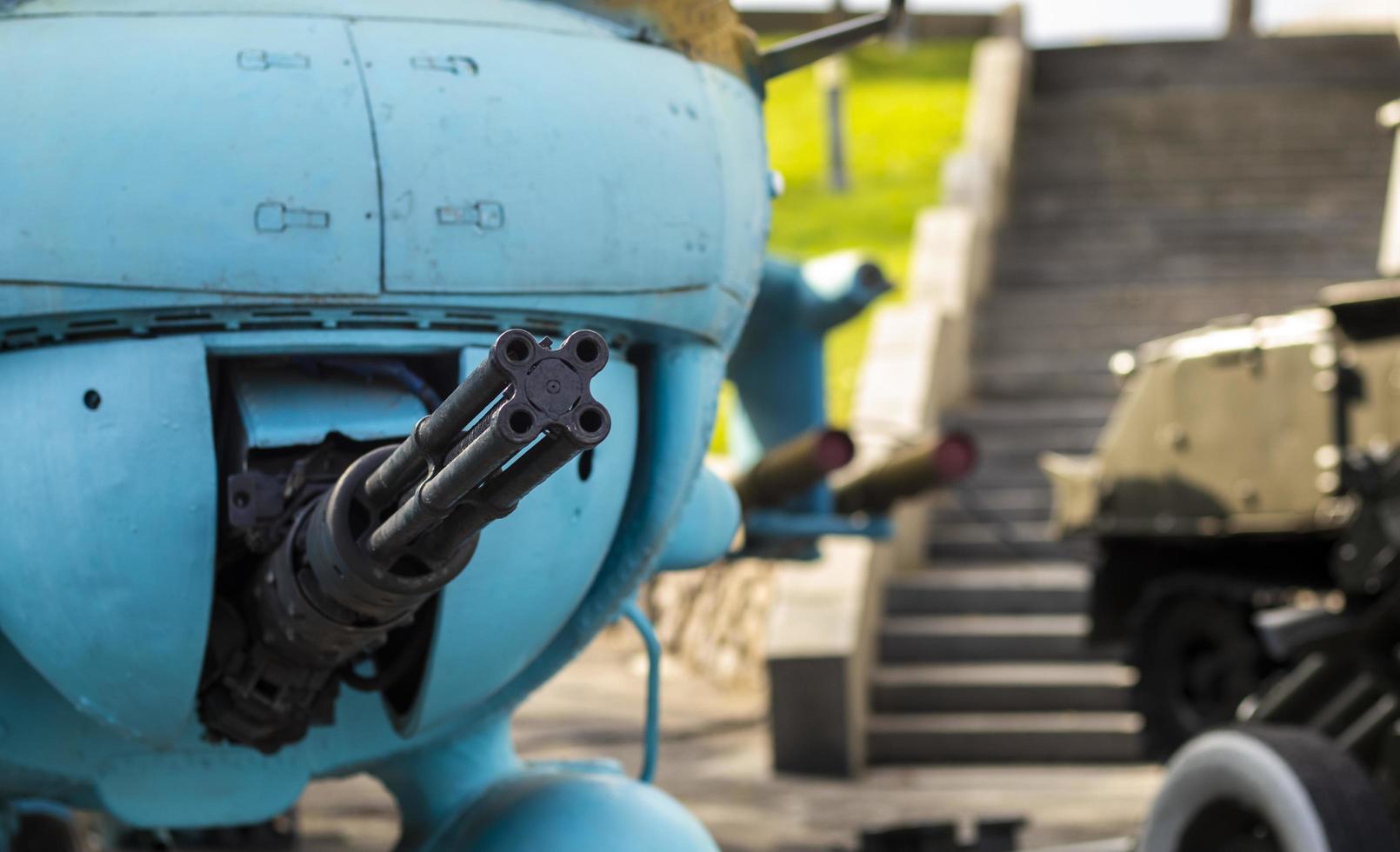 Selective focus of machine gun on combat helicopter. Attack helicopter, machine gun turret close-up. Rapid-fire helicopter gun. photo