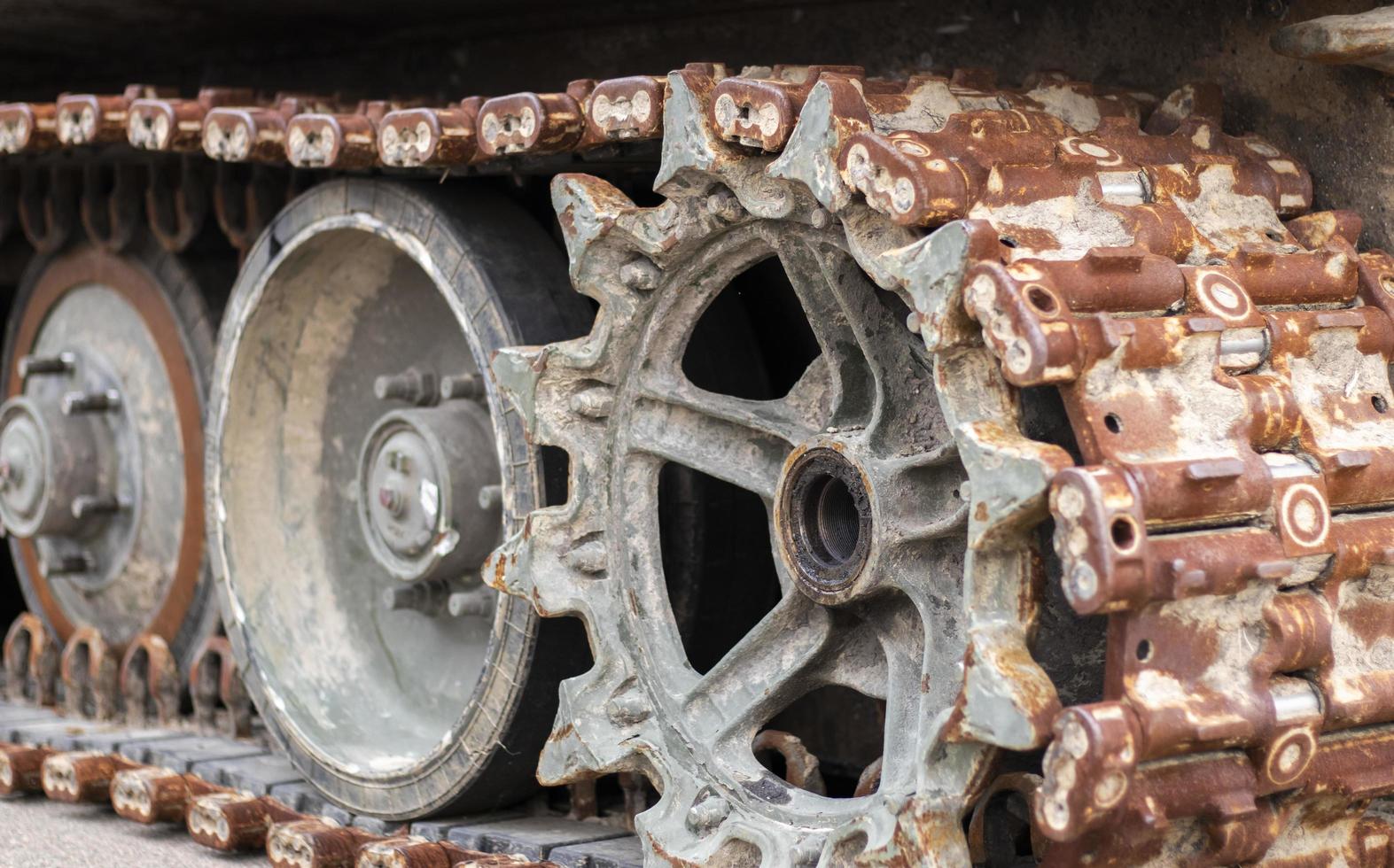 Destroyed, wrecked and burned T 72 tank. Russian Ukrainian conflict in 2022. Destroyed Russian military equipment. War of Russia against Ukraine. Rusty broken tracks with track rollers. photo