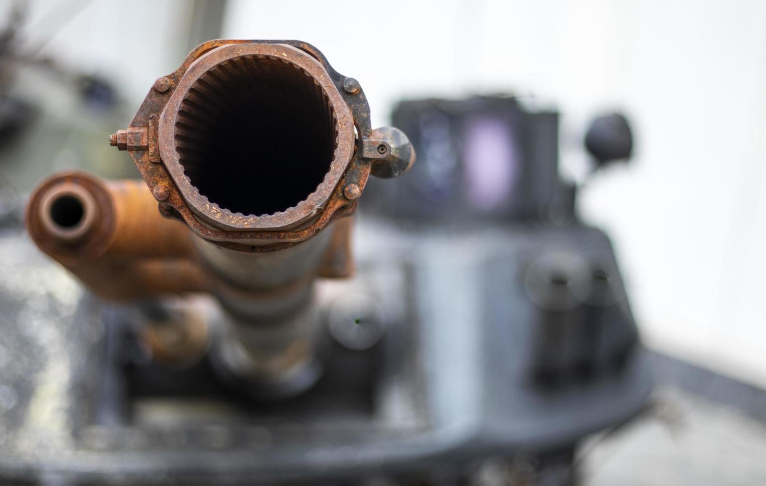 Tank gun, barrel muzzle of a military army close-up. Broken burnt tank. Barrel of a tank gun, selective focus. Destroyed and burned tank, military equipment in the vicinity of Kyiv. War in Ukraine. photo