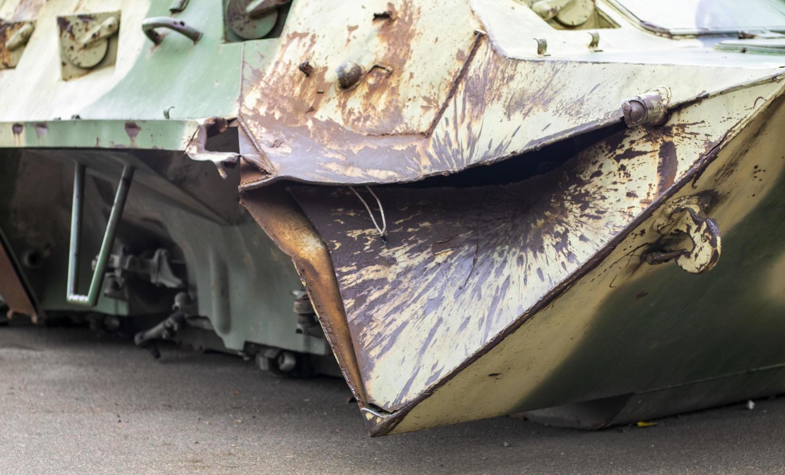 Russian combat vehicle, with holes in the armor. Destroyed military armored vehicles, disabled, blown up and destroyed. Armor metal background with bullet holes. Hole from cumulative penetration. photo