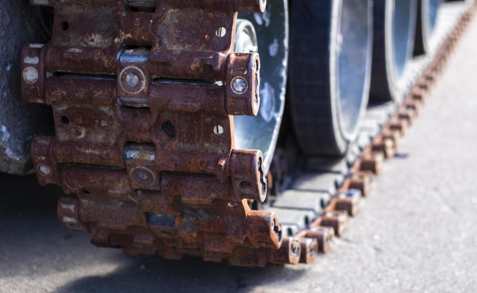 Rusty broken tracks with track rollers of a wrecked tank. Russian battle tank destroyed during the fighting during the Russian invasion of Ukraine, 2022. Remains of Russian military equipment. photo