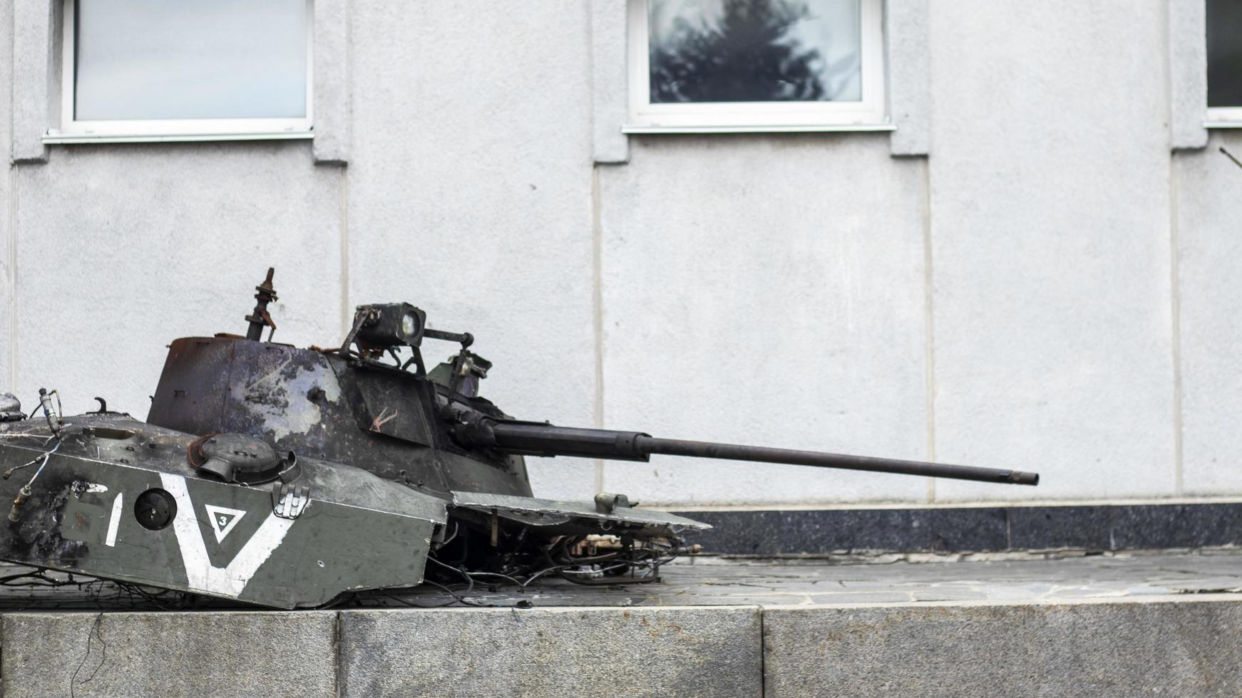 War in Ukraine. Destroyed tank with torn off turret. Broken and burned military tanks. Designation of a sign or symbol in white paint on the tank. Destroyed military equipment. War against Ukraine. photo