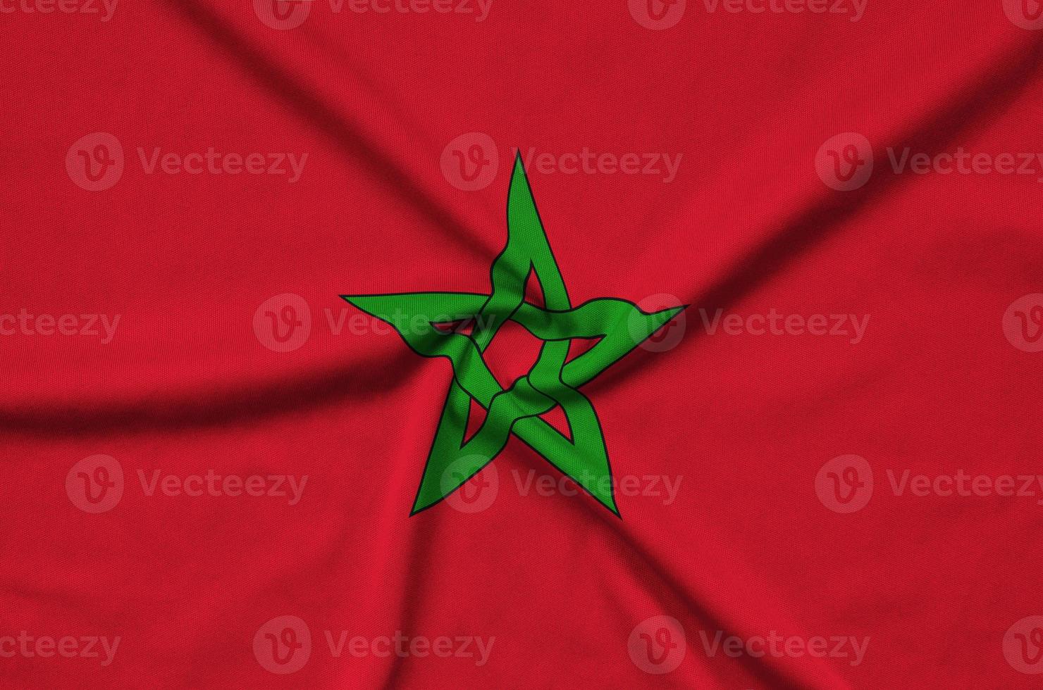 Morocco flag is depicted on a sports cloth fabric with many folds. Sport team banner photo