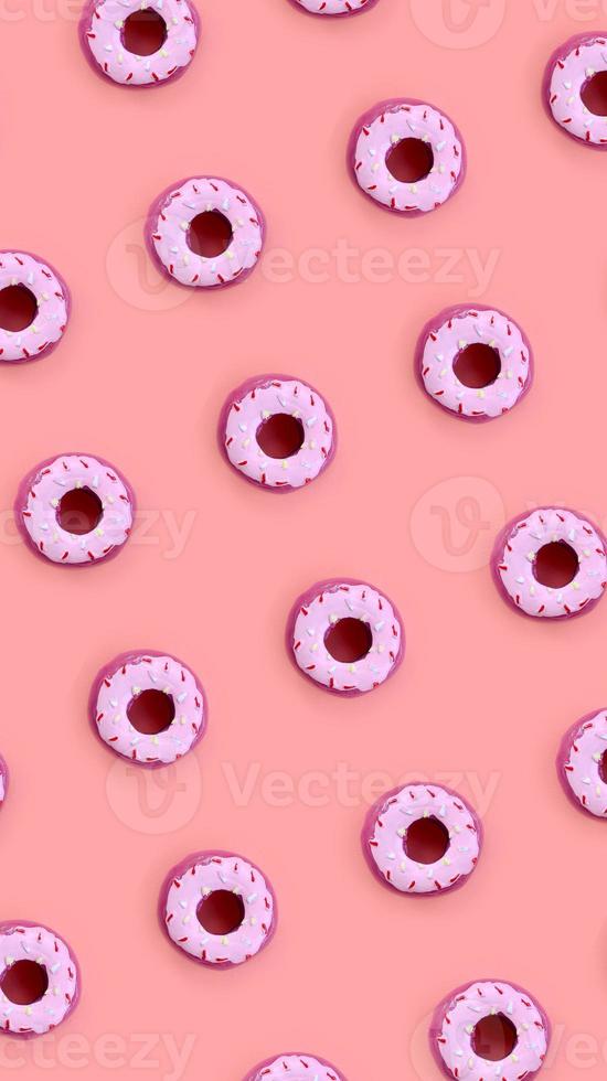 Many small plastic donuts lies on a pastel colorful background. Flat lay minimal pattern. Top view photo