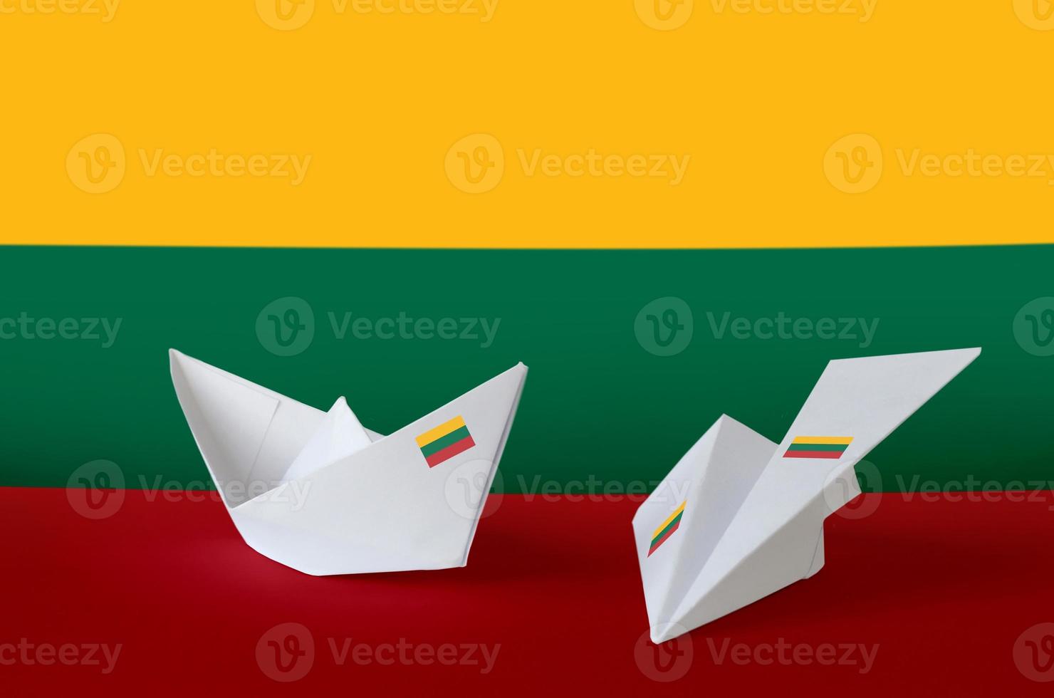 Lithuania flag depicted on paper origami airplane and boat. Handmade arts concept photo