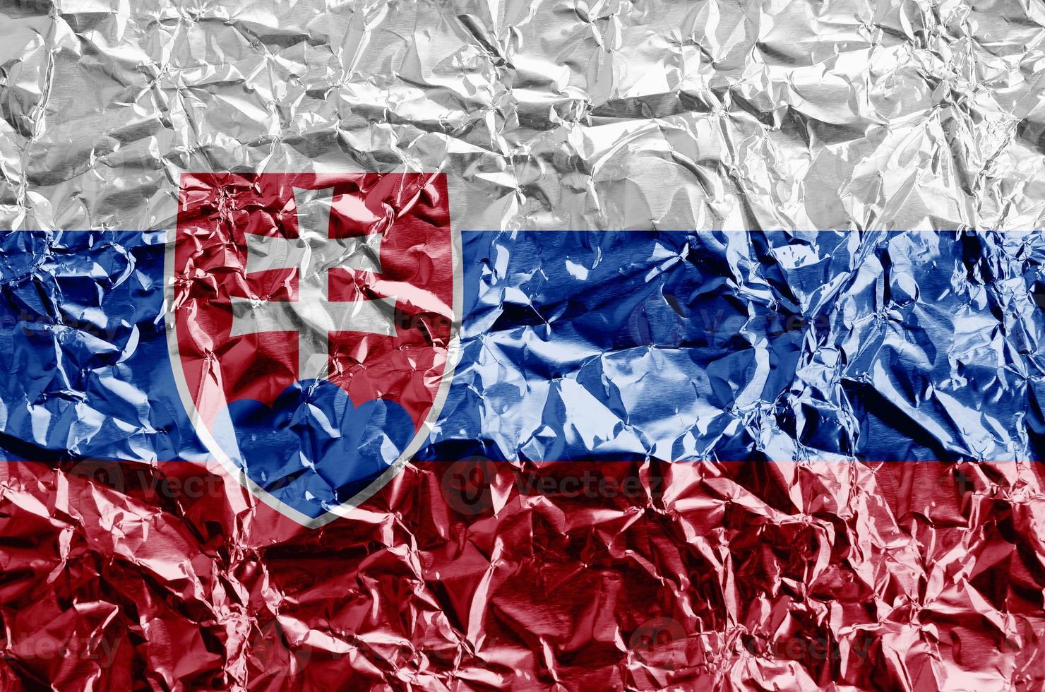 Slovakia flag depicted in paint colors on shiny crumpled aluminium foil closeup. Textured banner on rough background photo