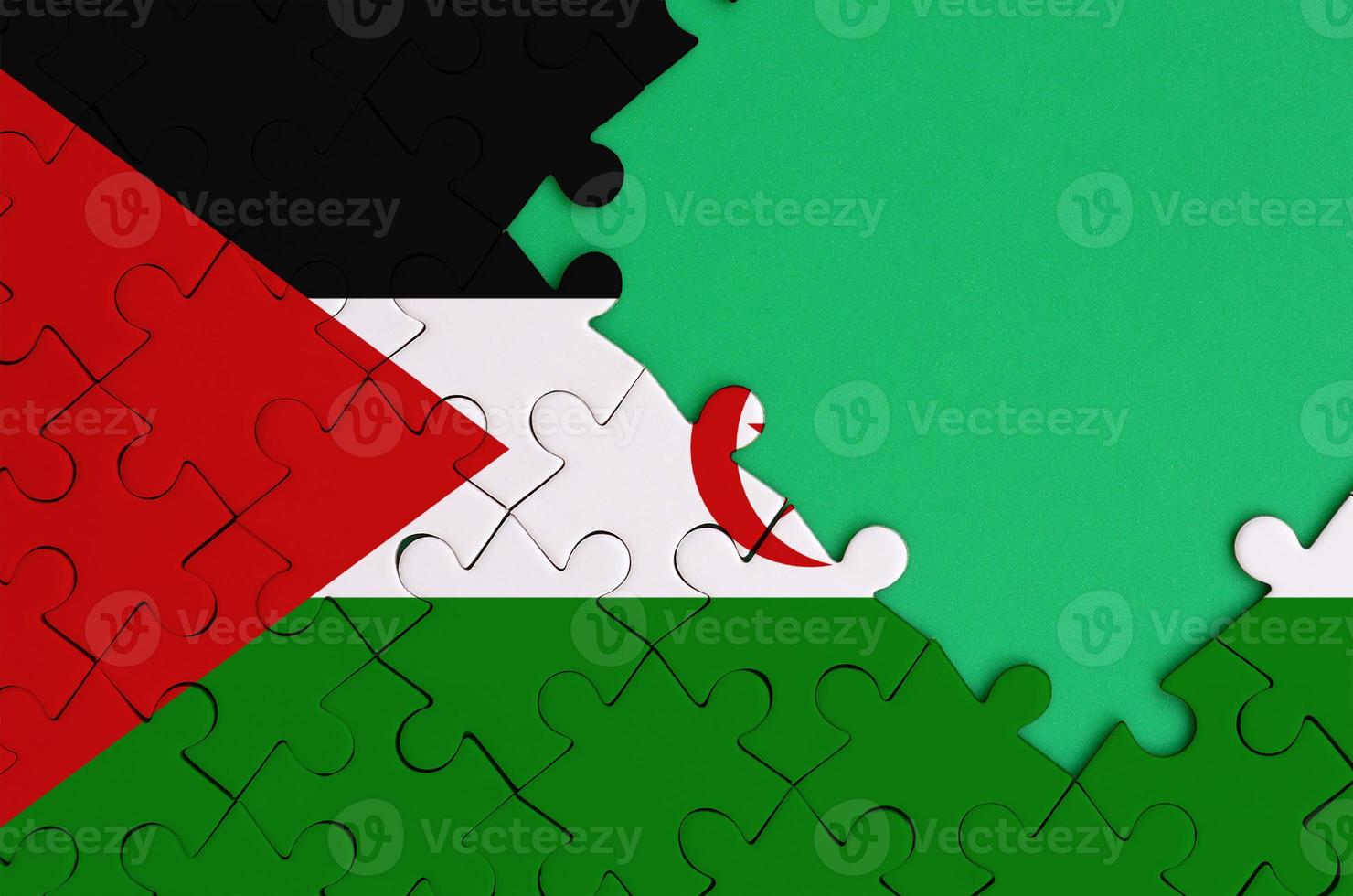 Western Sahara flag is depicted on a completed jigsaw puzzle with free green copy space on the right side photo