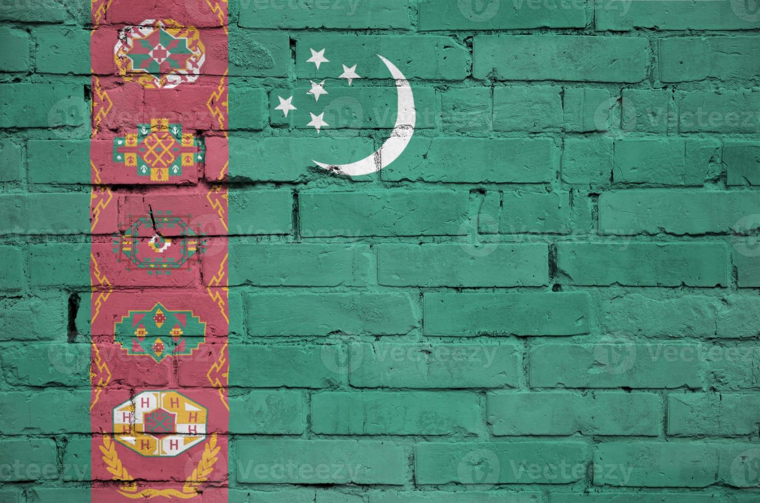 Turkmenistan flag is painted onto an old brick wall photo