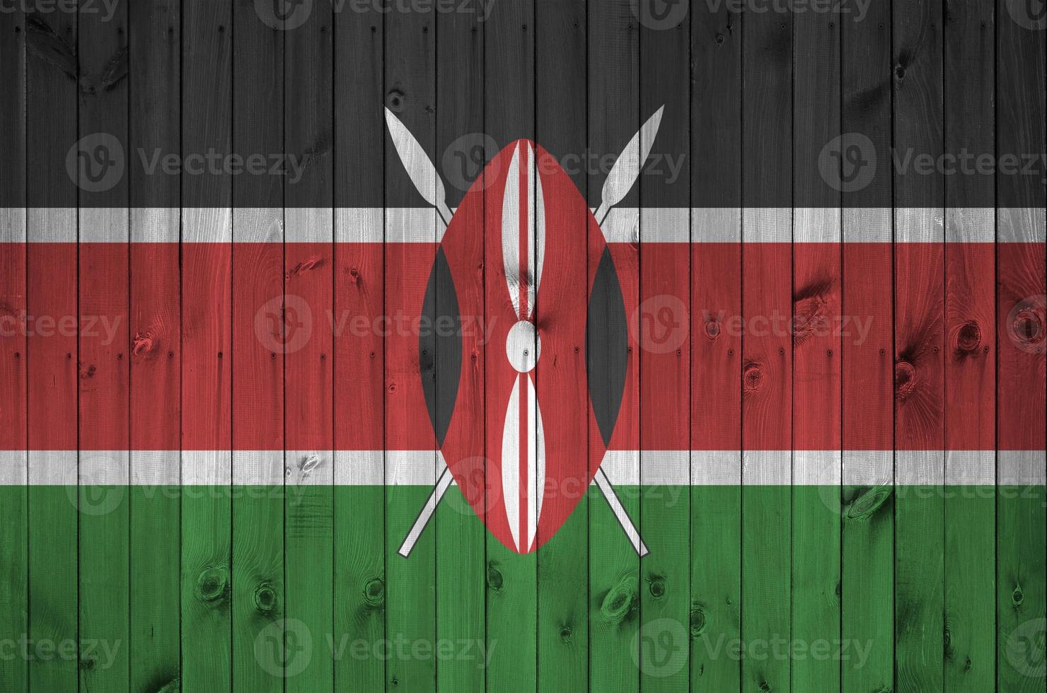 Kenya flag depicted in bright paint colors on old wooden wall. Textured banner on rough background photo