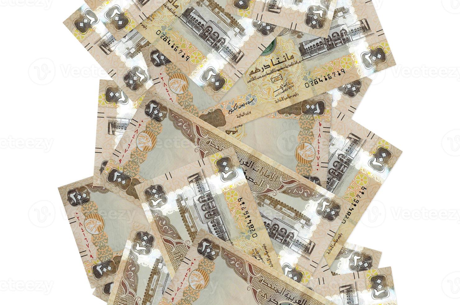 200 UAE dirhams bills flying down isolated on white. Many banknotes falling with white copyspace on left and right side photo