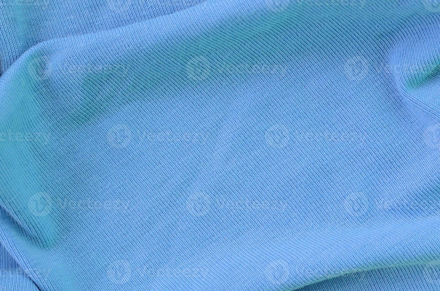 The texture of the fabric in blue color. Material for making shirts and blouses photo