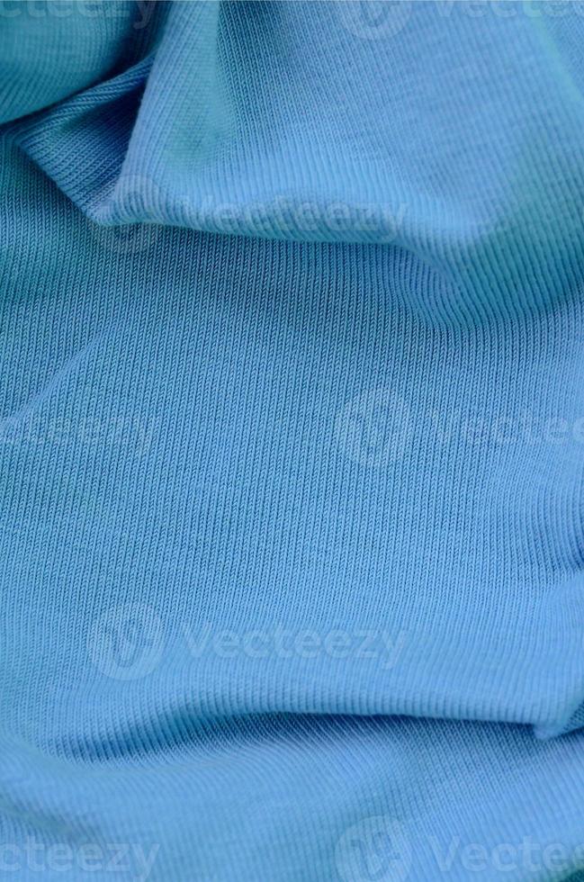 The texture of the fabric in blue color. Material for making shirts and blouses photo