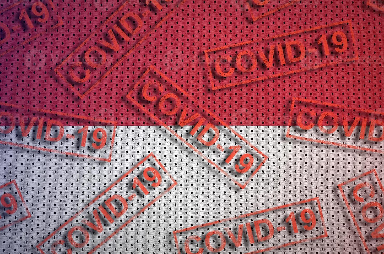 Indonesia flag and many red Covid-19 stamps. Coronavirus or 2019-nCov virus concept photo