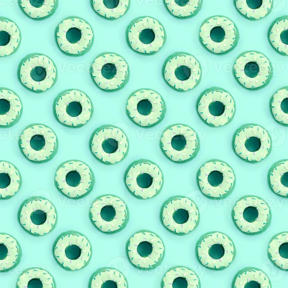 Many small plastic donuts lies on a pastel colorful background. Flat lay minimal pattern. Top view photo