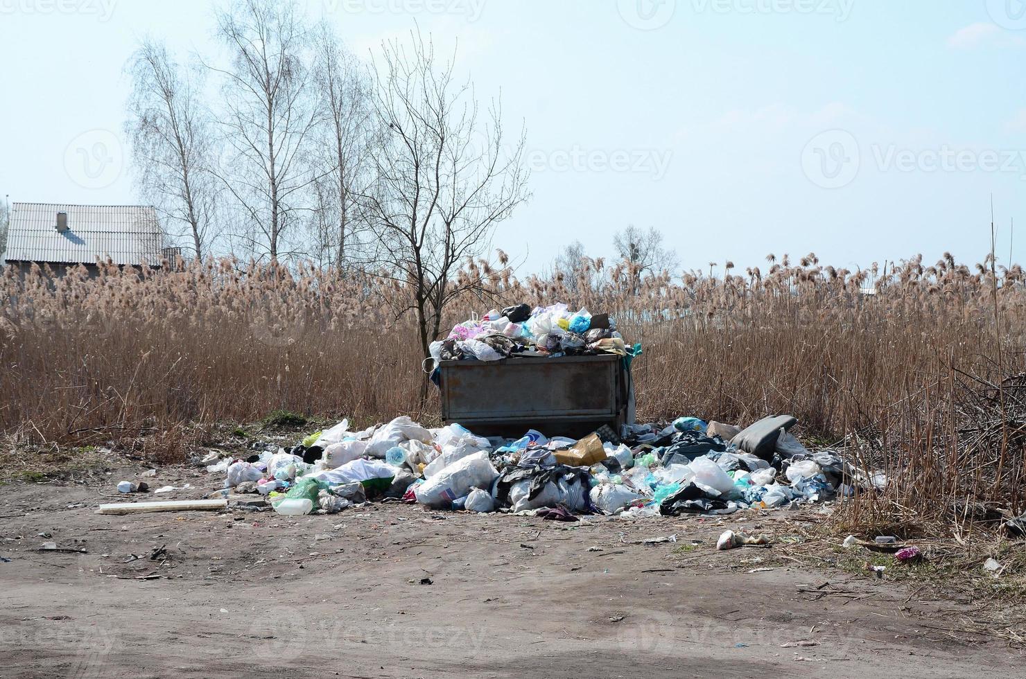 Garbage can is packed with garbage and waste. Untimely removal of garbage in populated areas photo