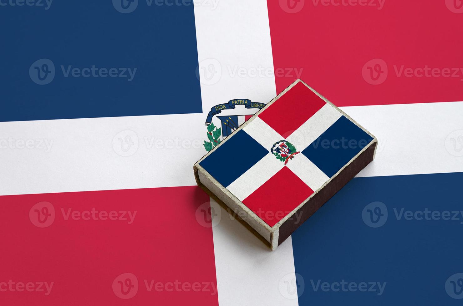 Dominican Republic flag is pictured on a matchbox that lies on a large flag photo